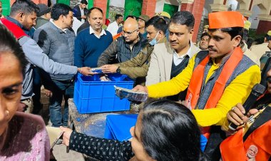 वाराणसी: जिलाधिकारी ने महाकुंभ से लौटे श्रद्धालुओं में खाद्य पैकेट वितरित किया